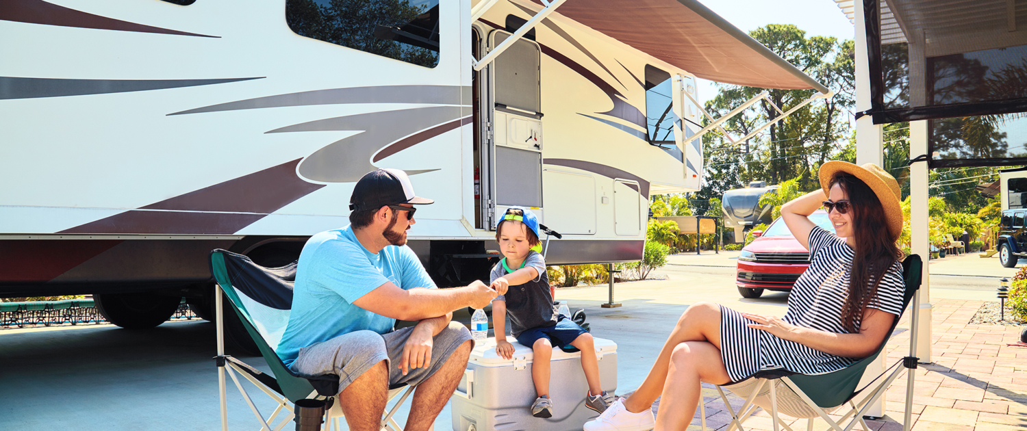 Mother, Father, and Son sitting in front of RV