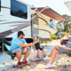 Mother, Father, and Son sitting in front of RV