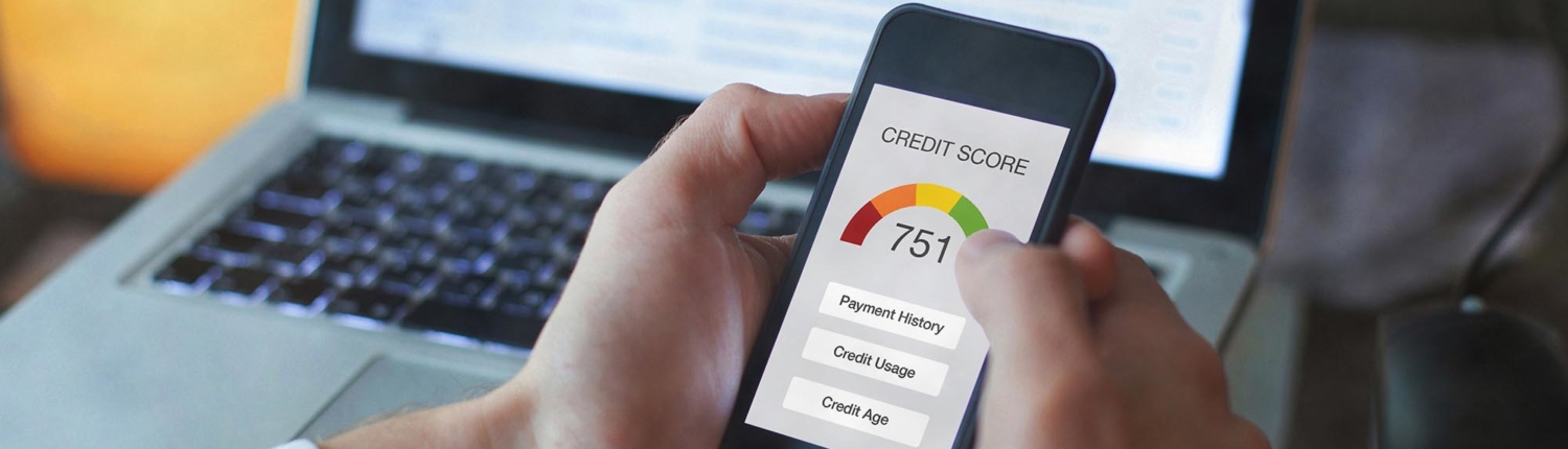 close up of hands holding phone with credit score