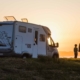 woman with child looking at the sunset by the rv_