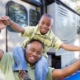 Child on dads shoulders infront of RV