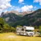 Side view of an RV by a scenic mountain