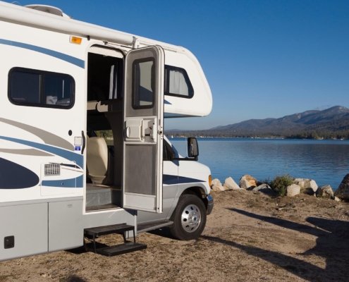 RV parked in front of a lake